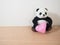 Soft panda doll with pink heart shape, fall in love