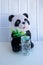 A soft Panda toy and a glass jar with a lid on a white background. Reusable packaging. Disaster of the planet. Concept of garbage