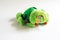 Soft plush toy for children - green ladybug. A beetle with sad eyes, red bells on its antennae, unrealistic color with black spots