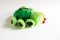 Soft plush toy for children - green ladybug. A beetle with sad eyes, red bells on its antennae, unrealistic color with black spots