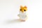 Soft plush toy hamster with orange head and white belly on a gray background.