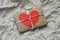 Soft pouch wrapped in craft paper and tie cord. Big red carton heart post card. Crumpled paper background texture.