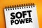 Soft power - ability to attract co-opt rather than coerce, text concept on notepad