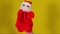Soft puppet toy of santa claus on hand. Santa claus puppet on yellow background. Close up. Concept of puppet show and