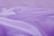 A soft purple satin material background