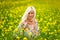 Soft, selective focus. Beautiful, attractive, blond woman in a yellow flower meadow