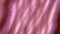 Soft and smooth shimmer of pink fabric. Beautiful pink pearly abstract background