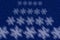 Soft snowflake pattern against a glitter blue night sky background