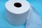 Soft strong and absorbent white toilet paper isolated on blue