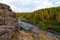 Soft sun rays in evening over beautiful valley with mountain river and many rapids. Ural, Russia