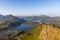 Soft sunlight over serene lakes and rugged hills in Vestvagoya, viewed from Offersoykammen