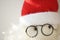 Soft toy abstract Santa Claus face with glasses and red hat, closeup eyes