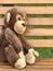 soft toy monkey sitting on a bench