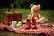 a soft toy and a pair of boots arranged for a picnic setting