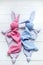 Soft toy. Sleeping pink and blue rabbit or Bunny. On white wooden background. Hand made