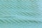 Soft turquoise fabric with arrow pattern background texture pattern.