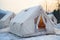 Soft winter focus on mountain resorts white camping tents for visitors