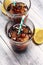 Softdrink with ice cubes, lemon and straw in glass