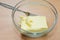 Softened butter in a glass dish, cooking home-made cake