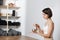 Softly smiling woman sitting straight, using singing bowl in a yoga practice