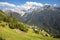 The Soglio village uder the alps meadows and Piz Badile, Pizzo Cengalo, and Sciora peaks in the Bregaglia range - Switzerland