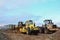 Soil Compactor, bulldozer and wheel loader during the construction of road at construction site. Heavy machinery for leveling the