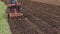 Soil earth and tractor fertilizing field. Heavy agricultural machinery