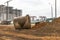 Soil excavation at the construction site. A pile of sand and earth after earthworks. Trench in the ground