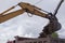 Soil loading by excavator bucket into the dump truck body.