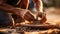 Soiled hand shaping clay in an outdoor workshop