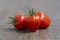 Solanum lycopersicum cultivated red ripened strawberry tomato, tasty fresh fruit with green stem
