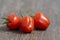 Solanum lycopersicum cultivated red ripened strawberry tomato, tasty fresh fruit with green stem
