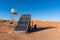 Solar energy panel and water tank in the desert. Sun as energy resource concept