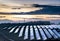 Solar energy park and conventional electricity pylon at sunset,Hampshire,England,UK