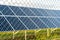 Solar farm with photovoltaic panels behind the fence