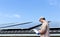 Solar panel energy. Electrical engineer man is working checking documents in solar station against house roof and blue sky.