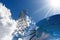 Solar Panel and High Voltage Tower on Blue Sky with Clouds and Sunbeams