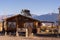 Solar panel on the roof of a wooden cottage in a semi-desert area with mountains in the background