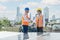 Solar panel technician on roof. Engineer and Young technician shake hands around wind solar station