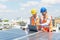 Solar panel technician on roof. Engineer and Young technician in solar power plant working on installing solar panel