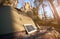 Solar panel and tent in the forest at foot of cliffs