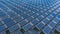 Solar panels in aerial view, rows array of polycrystalline silicon solar cells or photovoltaics in solar power plant floating on