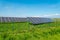 Solar panels in the field with blue sky produces renewable energy from the sun