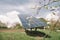 Solar panels are in the garden near the summer house. Extraction of solar energy for the home in the garden. Trees bloom on the