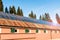 Solar panels partly covering the roof of a barn and blue sky