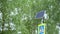 Solar panels and road sign with built-in flashing yellow traffic light. Close-up