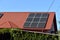 Solar panels on the roof of a country house, environmental production of solar energy in electrical