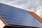 solar panels on the roof of a house. horizontal orientation, blue sky.