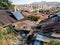 Solar panels and satellite dishes are installed on ancient tiled roofs in the slums of Ankara, Turkey. Garbage and old roofs of