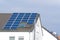 Solar panels on the tiled roof of a private house. Renewable clean green energy saving efficient photovoltaic solar panels on